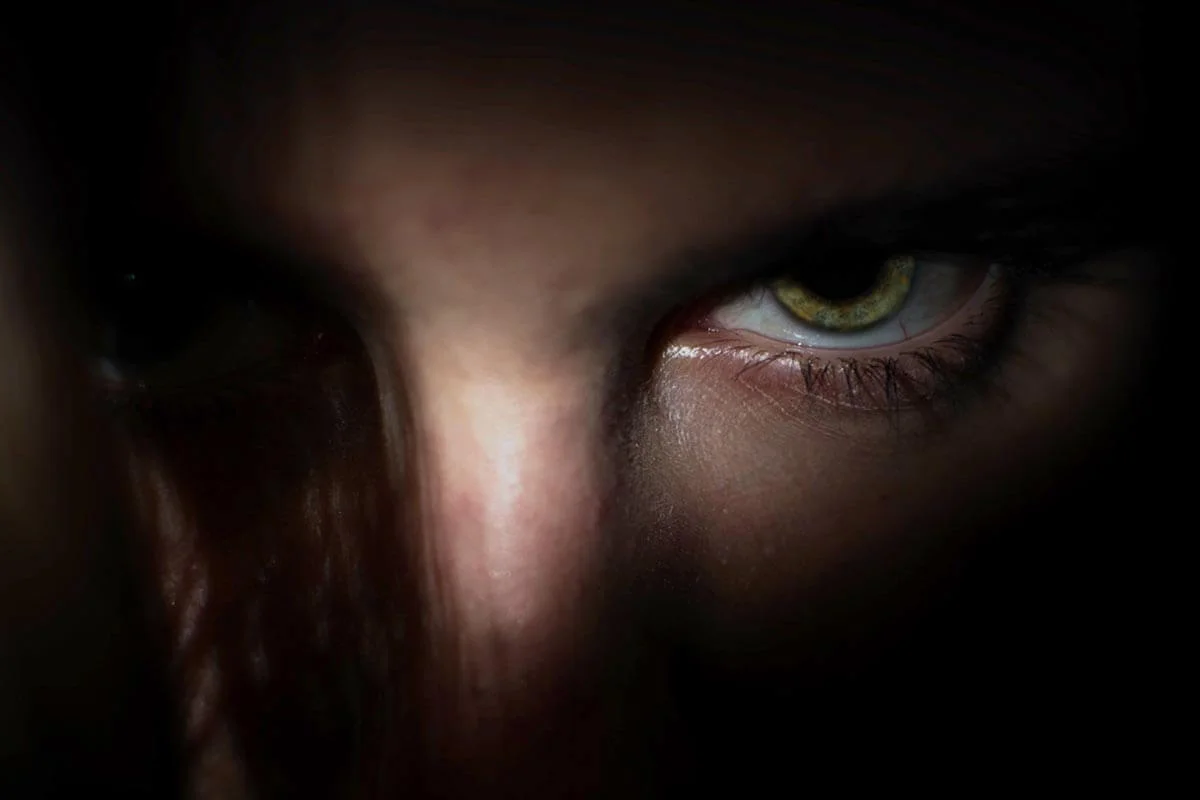 Angry eye staring out from the darkness